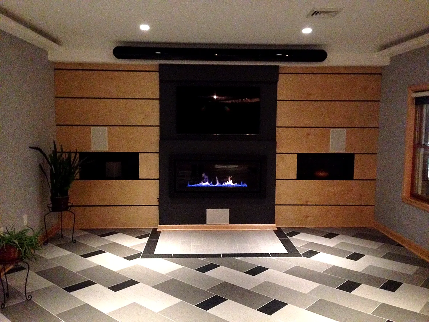 Great-room media wall with linear fireplace, integrated TV and concealed speakers